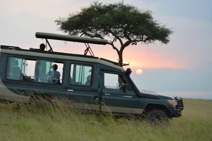 Safari vehicle at sunset in the Kenyan wild